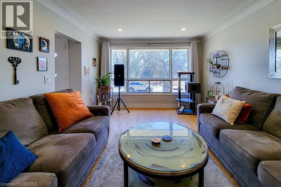 A living room with a glass coffee table and two couches.