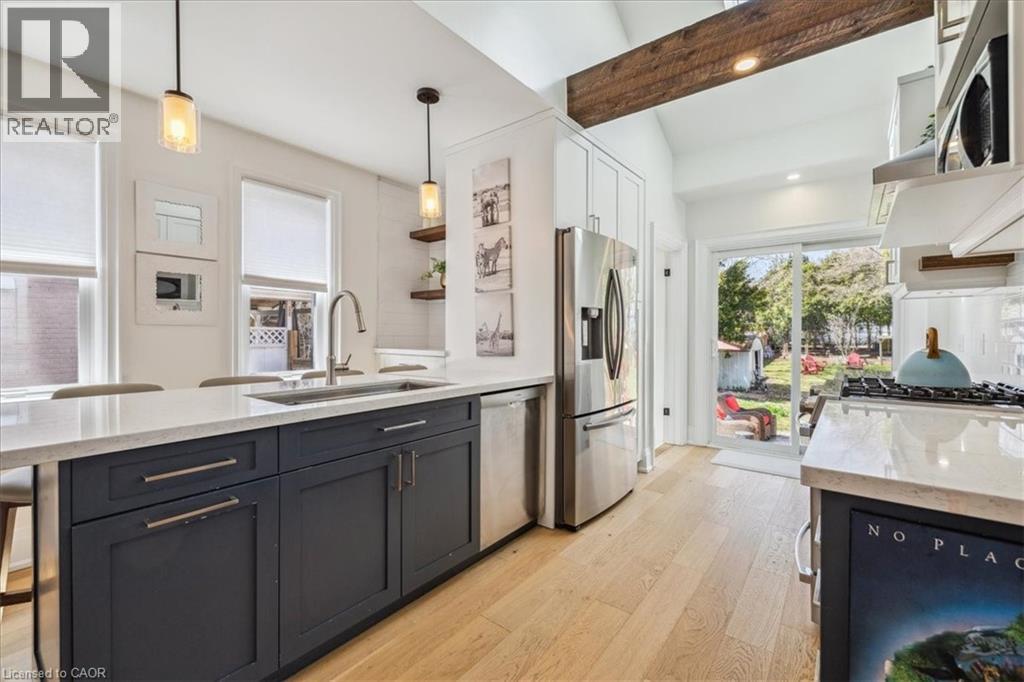 A modern kitchen with a large island and a refrigerator with a glass door.
