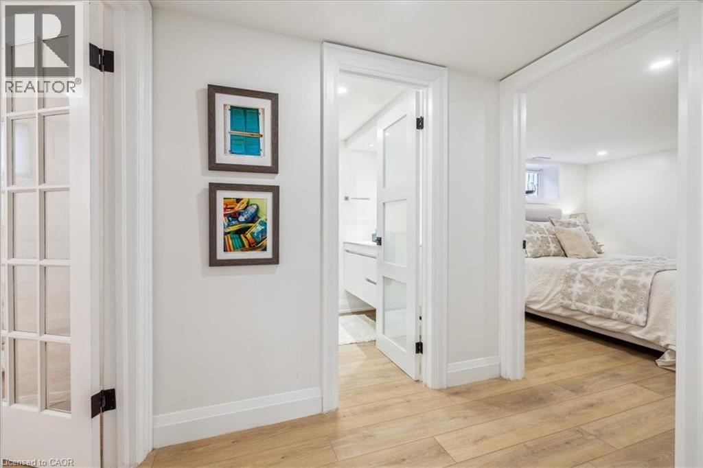 A bedroom with a bed and a painting on the wall.