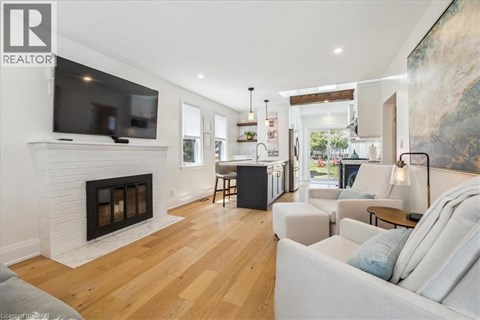 A living room with a fireplace and a television on the wall.