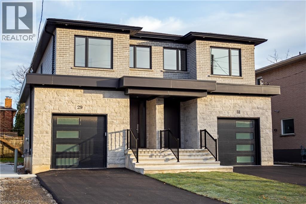 A modern house with a stone facade and black garage doors.