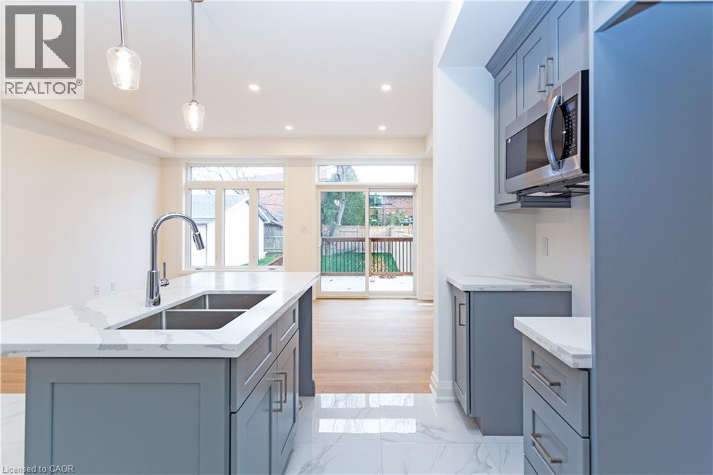 A modern kitchen with a sink and a microwave.