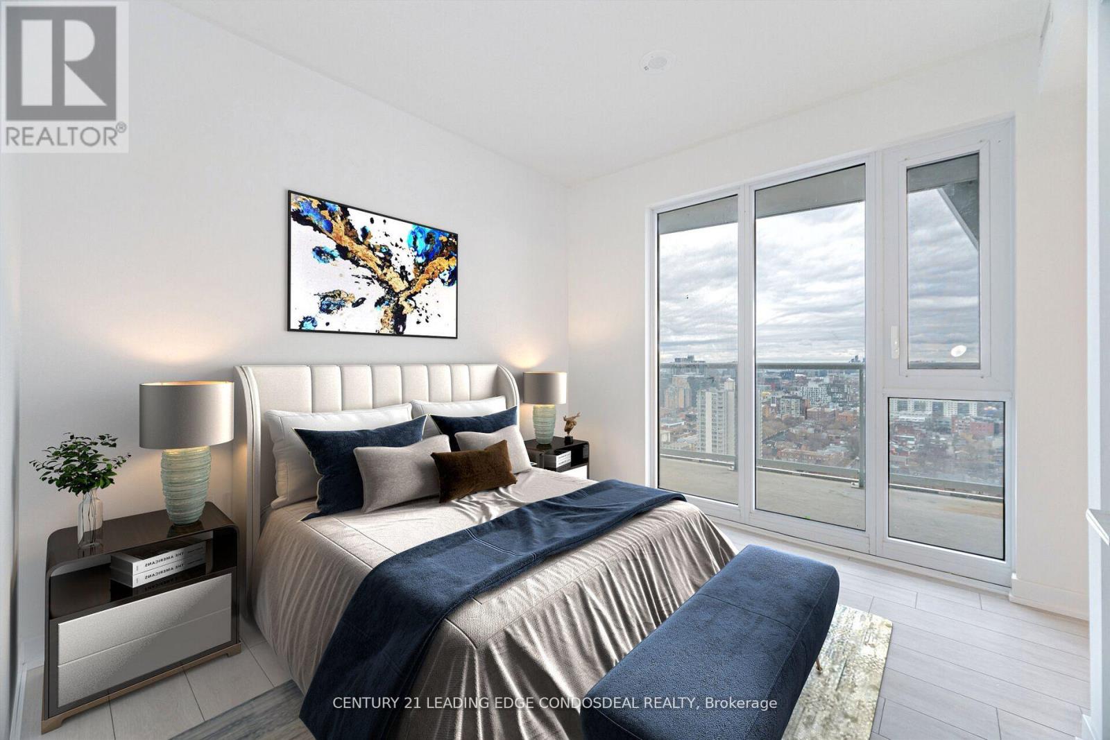 A bedroom with a large bed and a painting on the wall.