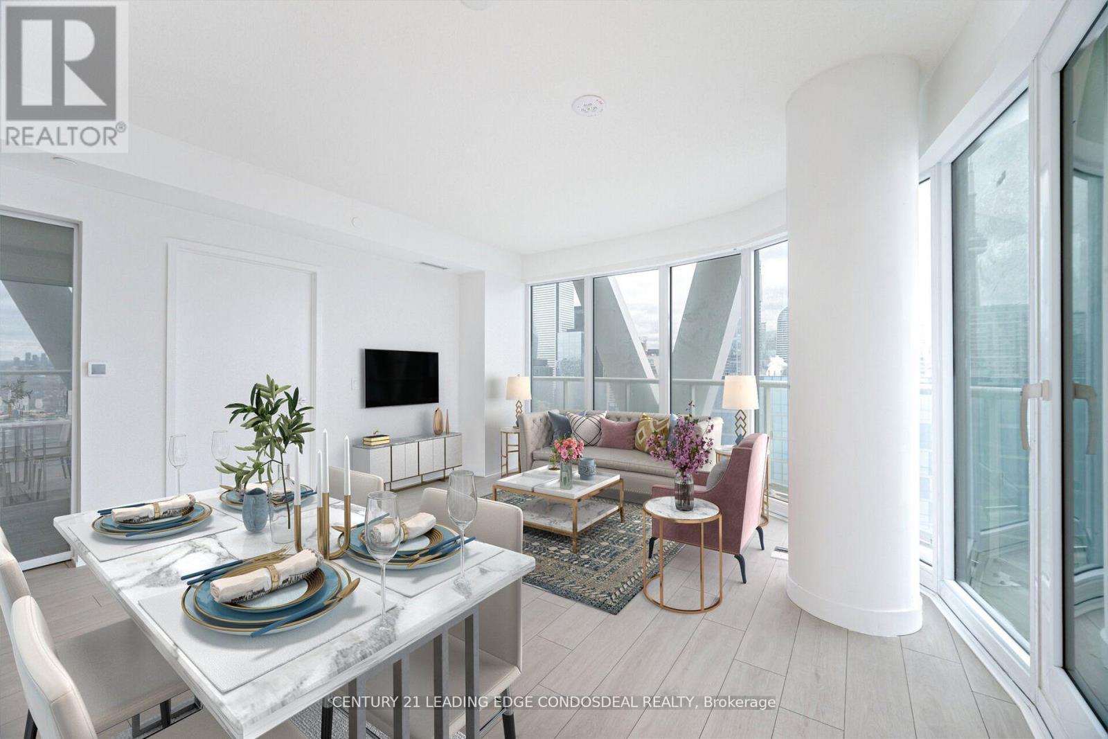 A modern dining room with a glass table and chairs.