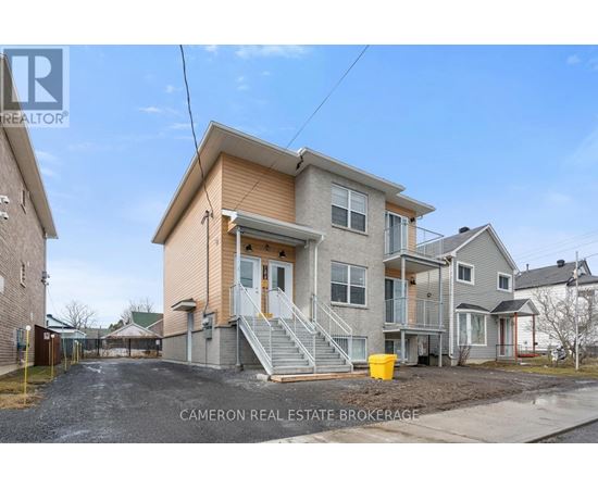 A two-story house with a garage is for sale.