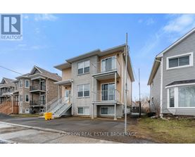 A row of houses with the middle one being the largest.