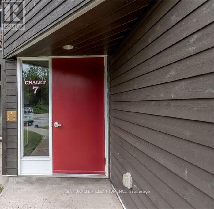 A red door with the number 7 on it.