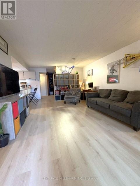 A living room with a grey couch and a television.