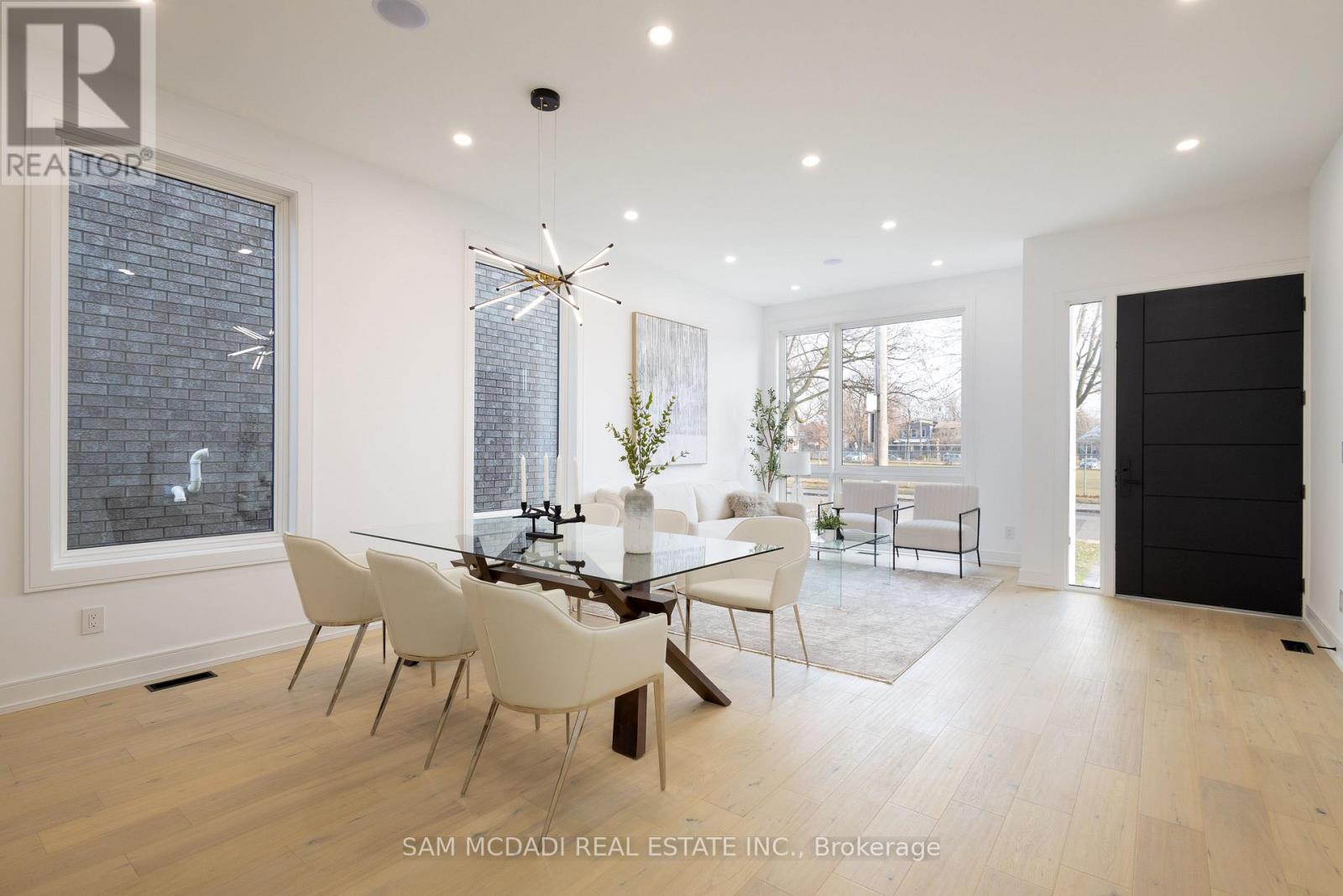 A dining room with a glass table and chairs.