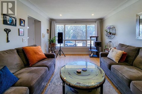 A living room with a glass coffee table and two couches.