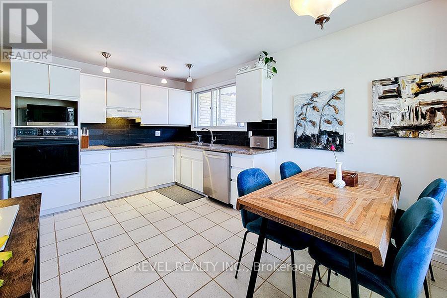 A kitchen with a table and chairs in the middle of the room.