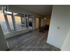 A room with a view of the city through large windows.