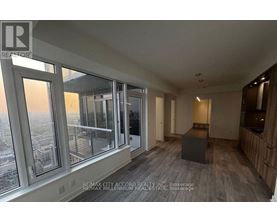 A room with a view of the city through large windows.