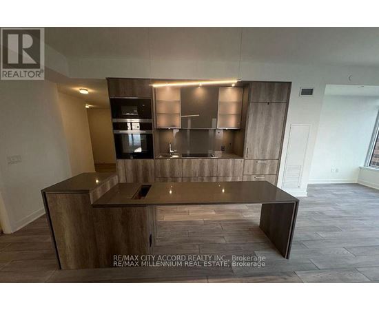 A modern kitchen with a wooden island and stainless steel appliances.