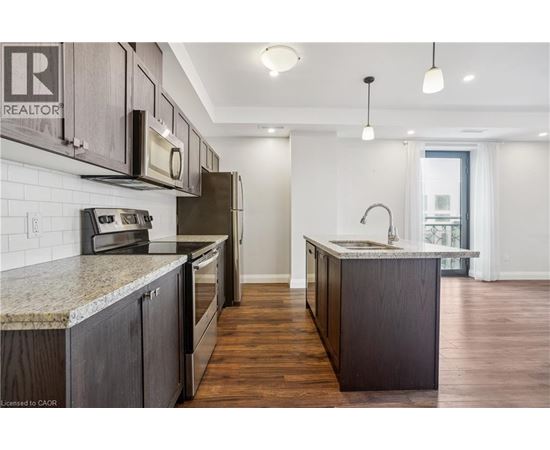 A kitchen with wooden cabinets and granite countertops.