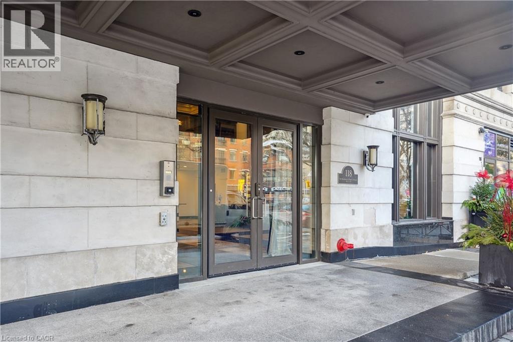 The image shows the front of a building with a glass door entrance and a sign that reads REALTOR.