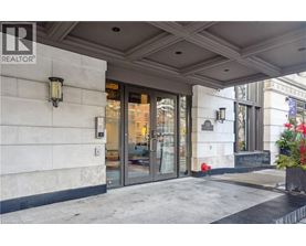 The image shows the front of a building with a glass door entrance and a sign that reads REALTOR.