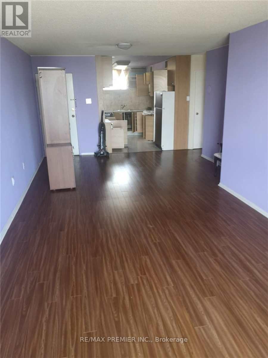 A room with wooden floors and a vacuum cleaner in it.