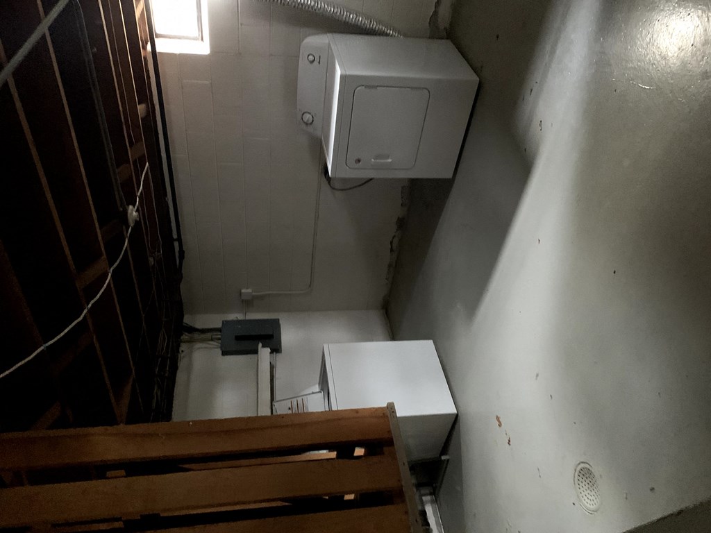 a small bathroom with a toilet and a paper dispenser