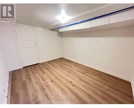 A room with wooden flooring and a white door.