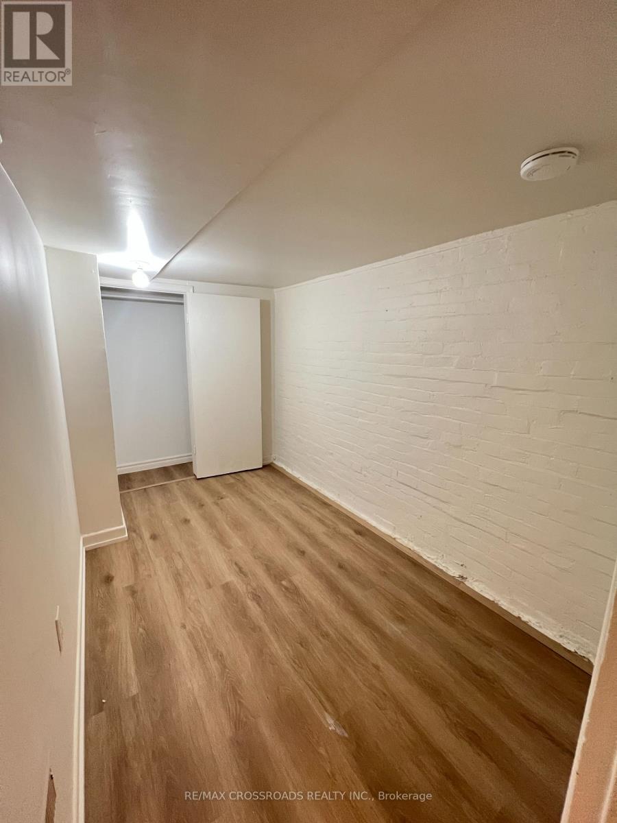 A room with wooden flooring and white walls.