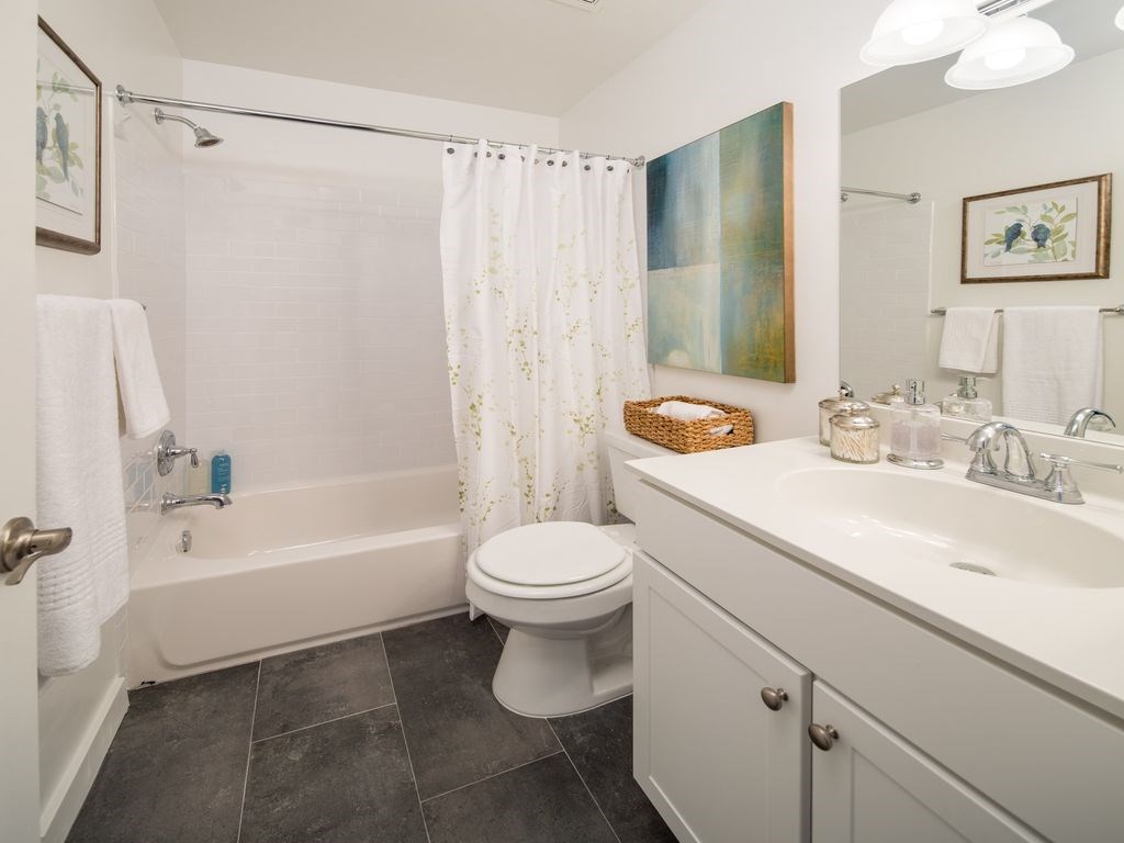 a bathroom with a sink toilet and a bath tub