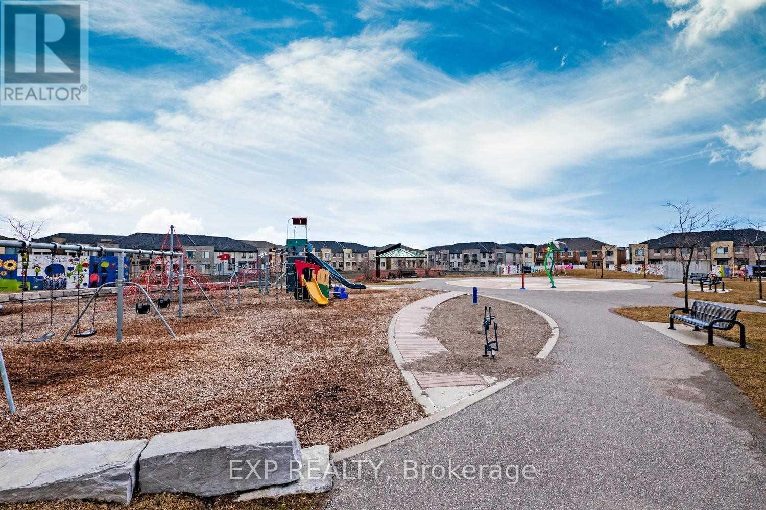 A playground with a slide and a walking path.
