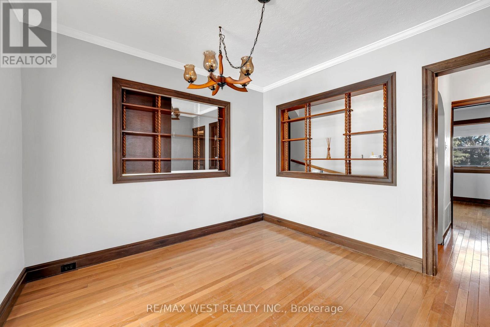 A room with wooden floors and a chandelier.