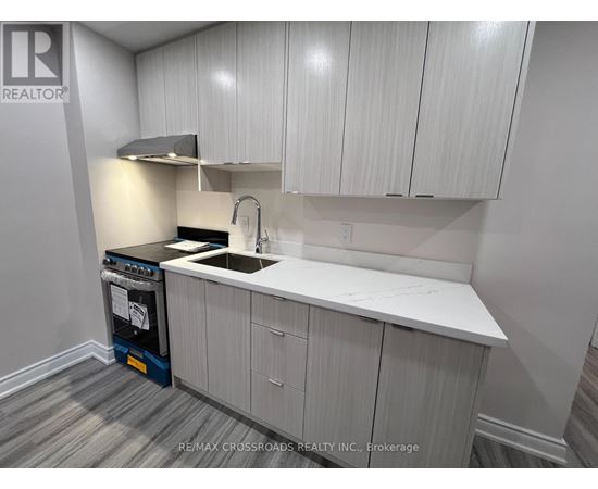 A kitchen with white cabinets and a black dishwasher.