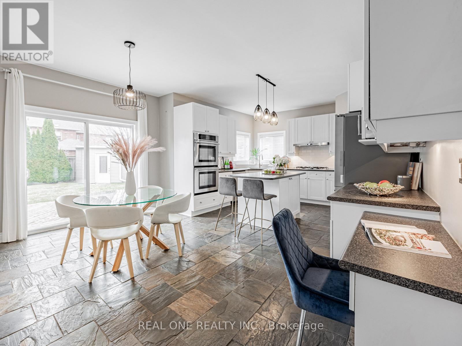 A modern kitchen with a glass table and chairs.