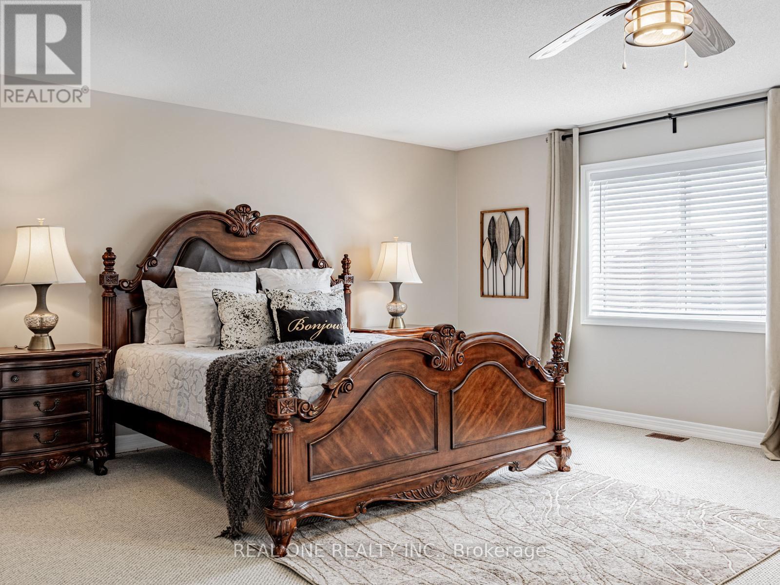 A bedroom with a large bed and a ceiling fan.