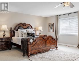 A bedroom with a large bed and a ceiling fan.