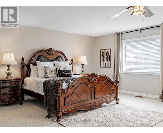 A bedroom with a large bed and a ceiling fan.