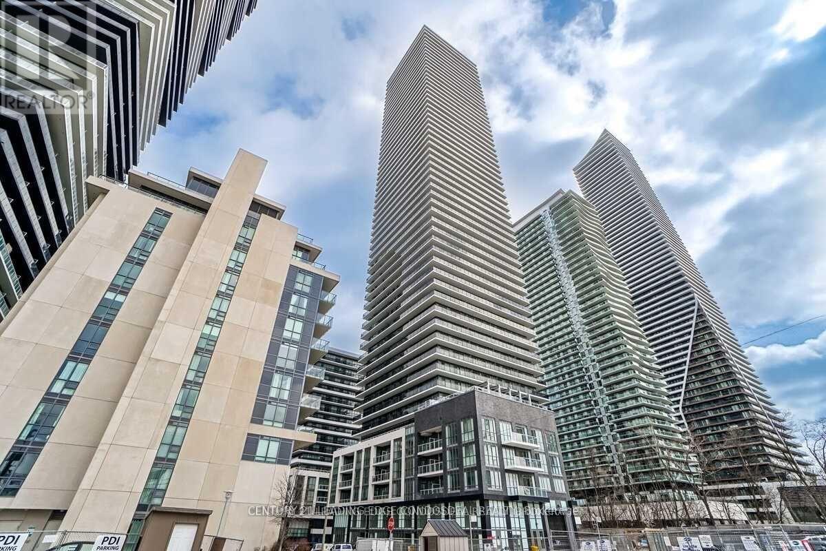 A modern cityscape with tall buildings and a clear sky.