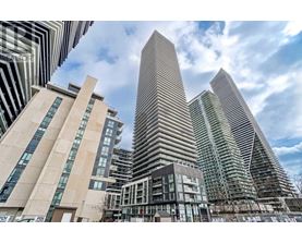 A modern cityscape with tall buildings and a clear sky.