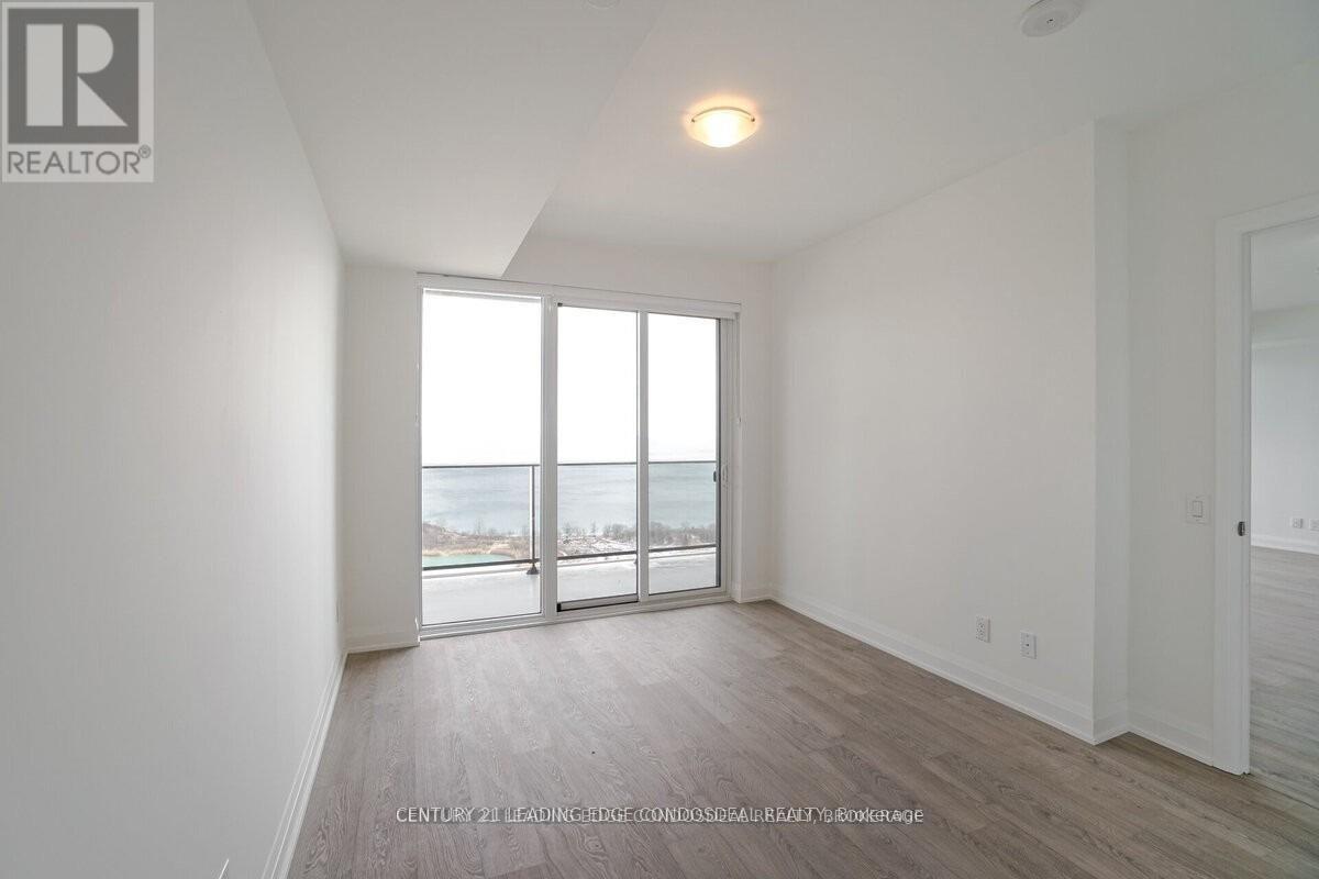 A spacious room with a view of the street through the sliding glass doors.
