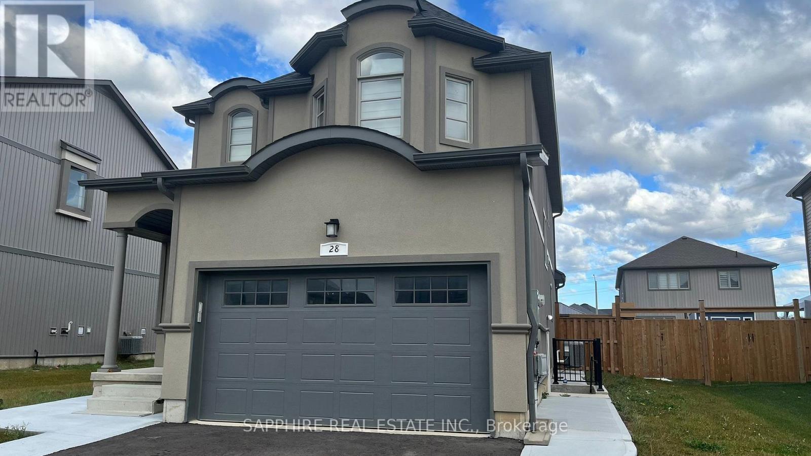 A modern house with a garage is for sale.