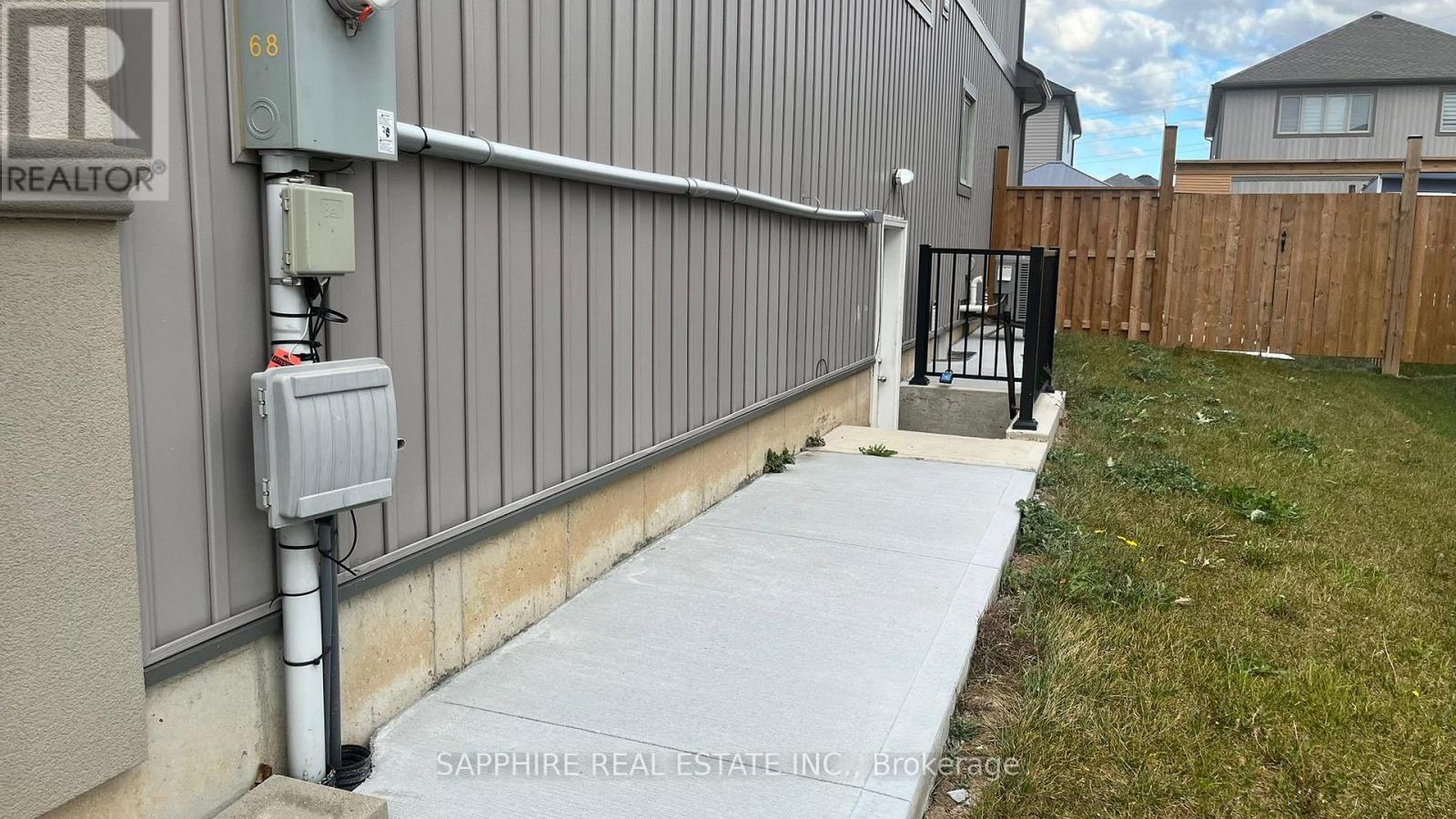 A grey building with a sign that says REALTOR on it.