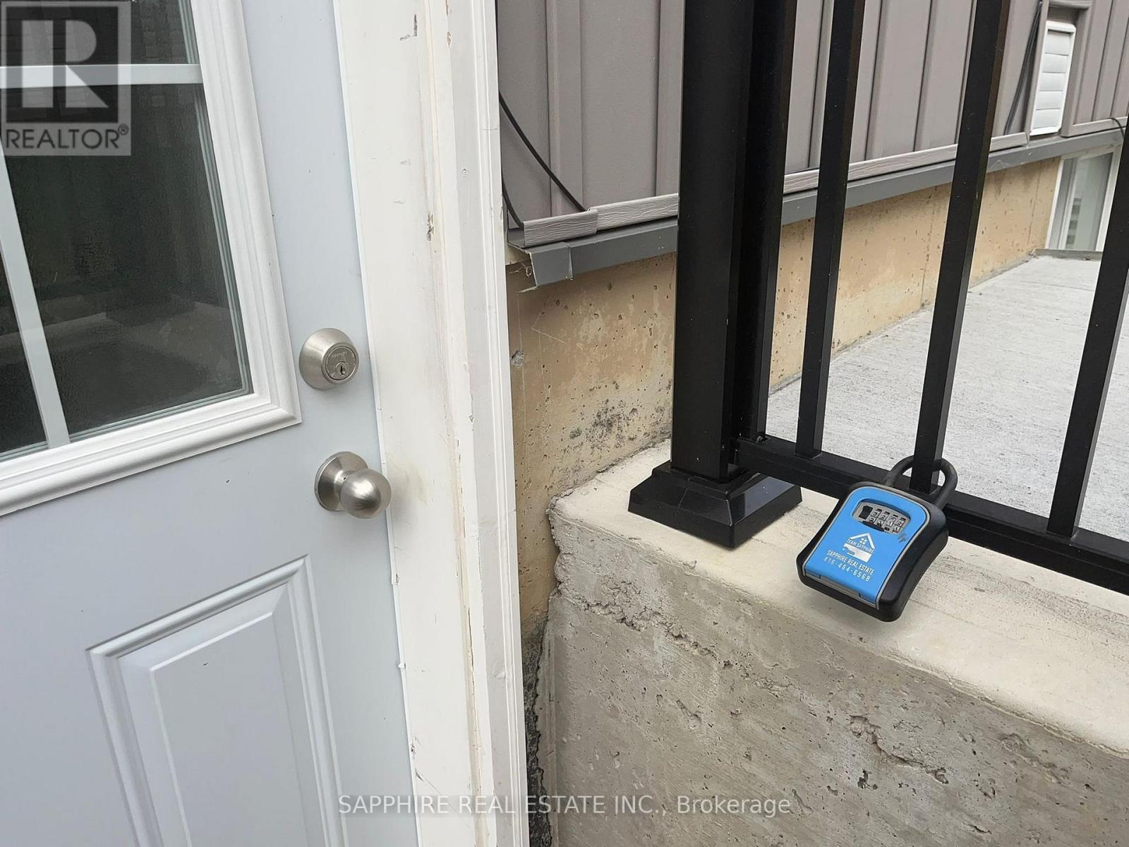 A blue device is sitting on a ledge next to a door.