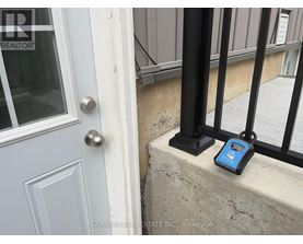 A blue device is sitting on a ledge next to a door.