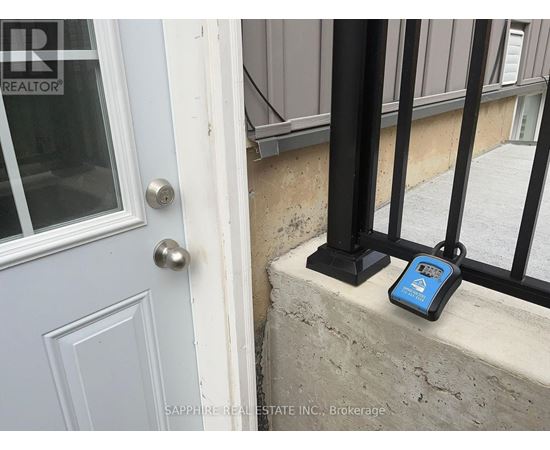 A blue device is sitting on a ledge next to a door.