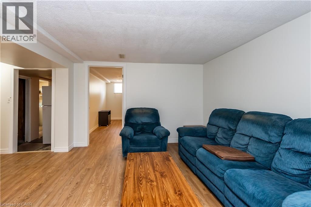 A living room with a blue couch and a wooden coffee table.