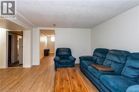 A living room with a blue couch and a wooden coffee table.