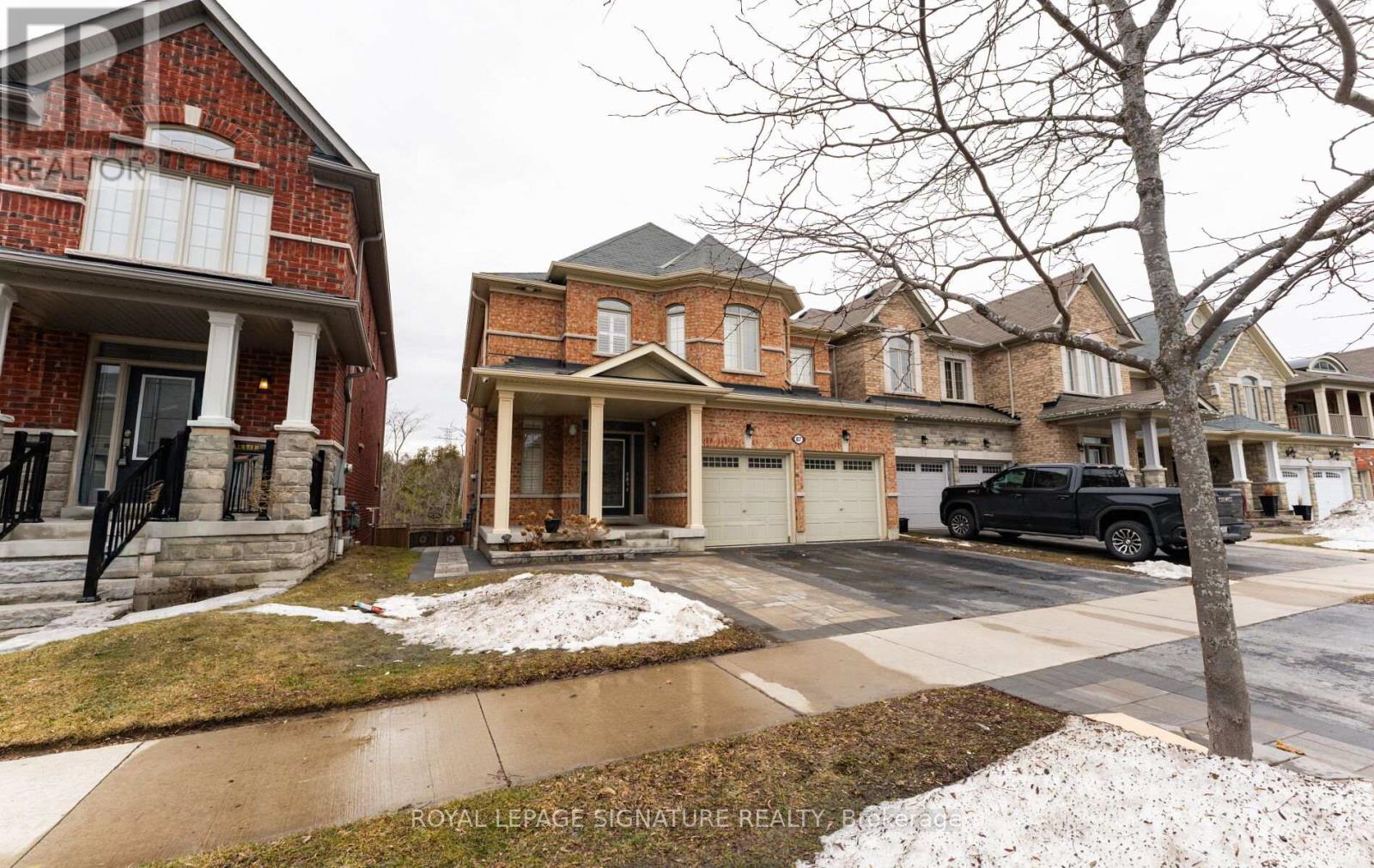 A row of houses with a car parked in front of the last one.