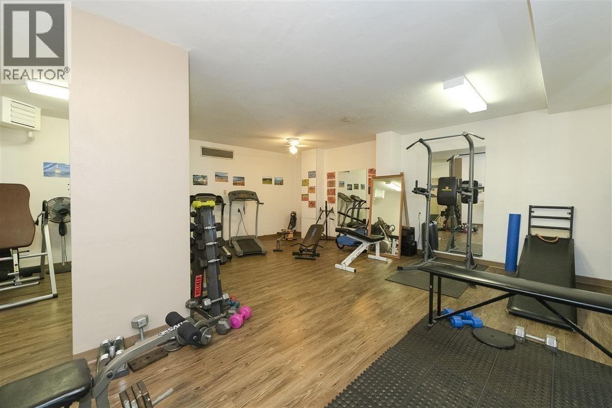A gym with a variety of equipment including weights and cardio machines.