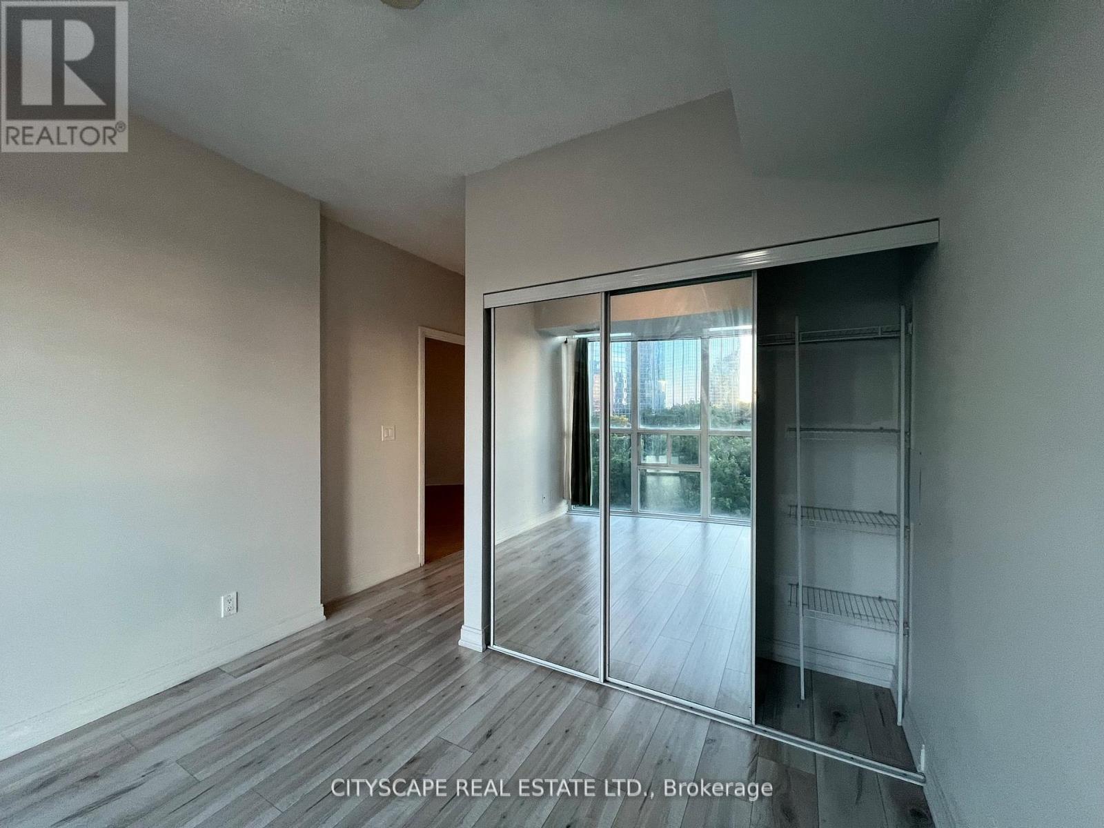 A room with a sliding glass door leading to a balcony.