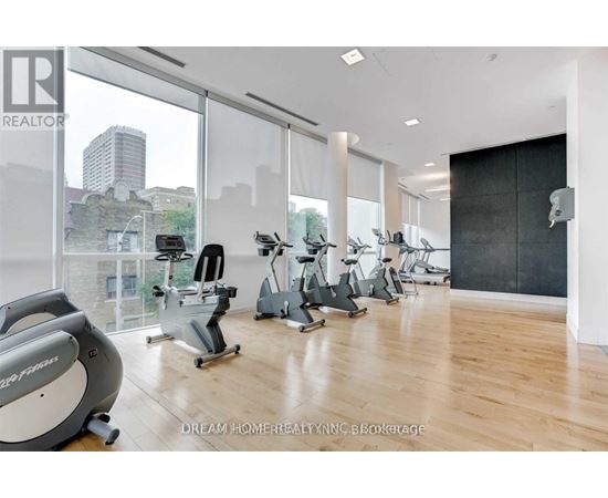 A gym with a view of the city skyline.