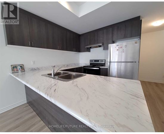 A kitchen with a marble countertop and stainless steel appliances.