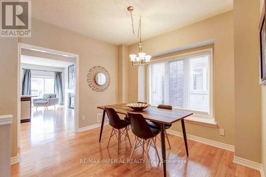A dining room with a wooden table and chairs.