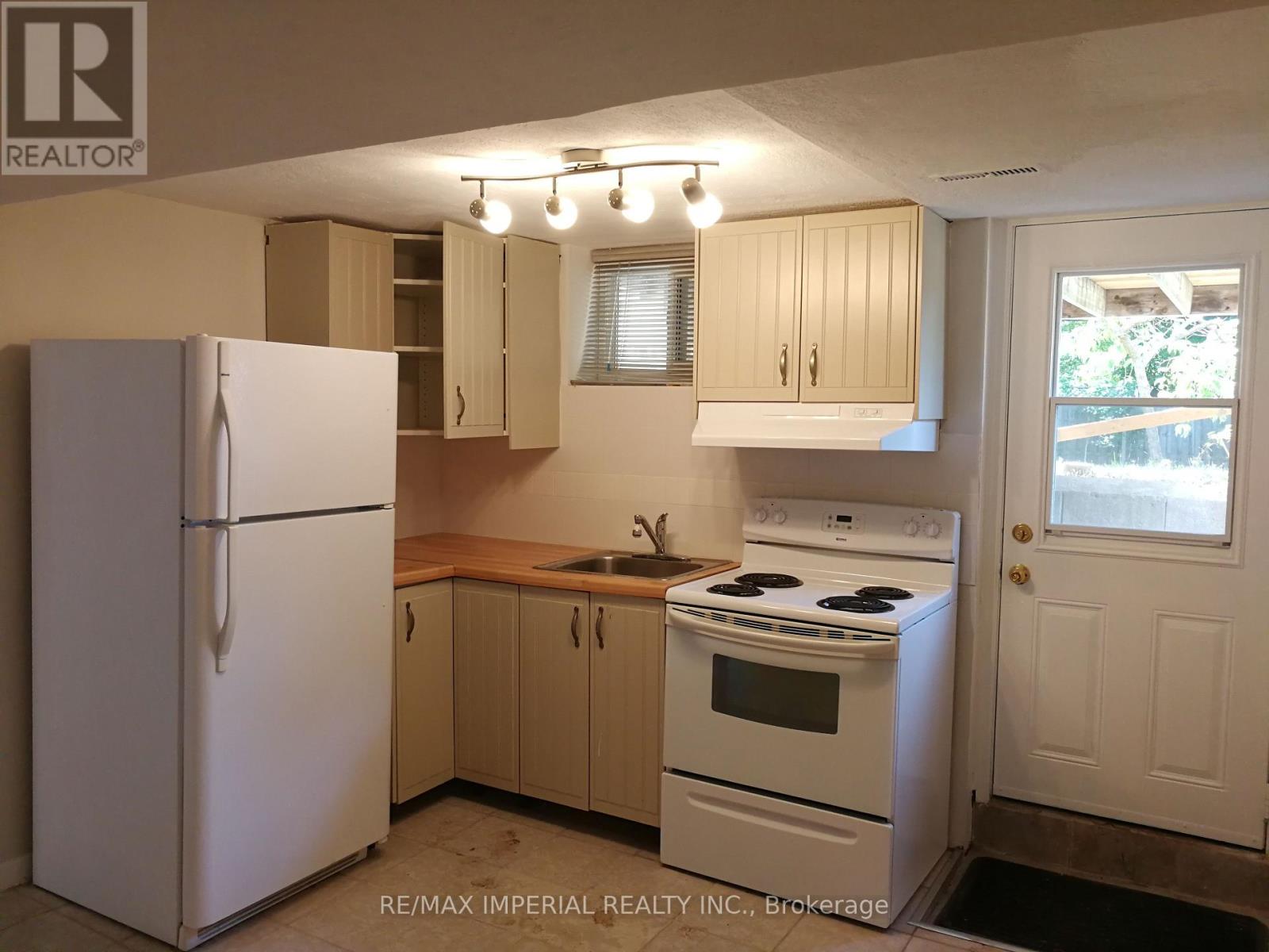 A kitchen with a white refrigerator and a white stove top oven.